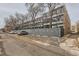 Apartment building with assigned parking and gray brick wall surround at 1050 N Corona St # 304, Denver, CO 80218