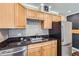 Well-lit kitchen with modern stainless steel appliances and wooden cabinets at 1050 N Corona St # 304, Denver, CO 80218