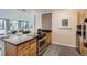 Kitchen with tile backsplash, stainless steel appliances, and view into living room at 1050 N Corona St # 304, Denver, CO 80218