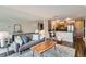 Open concept living room featuring a large mirror wall and modern decor at 1050 N Corona St # 304, Denver, CO 80218