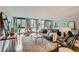 Bright living room with expansive windows, hardwood floors, and stylish contemporary furniture at 1050 N Corona St # 304, Denver, CO 80218