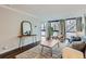 Bright living room features hardwood floors, large windows and modern decor at 1050 N Corona St # 304, Denver, CO 80218