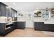 Updated kitchen with dark cabinetry, stainless steel appliances, and white backsplash at 11539 W 27Th Ave, Lakewood, CO 80215