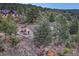 Aerial view of the home in a mountain setting, nestled among mature trees and natural landscaping, offering privacy at 345 Scrub Oak Way, Monument, CO 80132