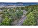 Aerial view of the home surrounded by mature trees and lush landscaping, highlighting its serene and private setting at 345 Scrub Oak Way, Monument, CO 80132