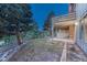 The backyard features mature trees, landscaping, and a patio area perfect for outdoor enjoyment and entertainment at 345 Scrub Oak Way, Monument, CO 80132