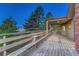 Large, covered deck with views, benches and wood railing detail, perfect for entertaining and enjoying the outdoors at 345 Scrub Oak Way, Monument, CO 80132