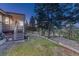 Exterior view of home featuring mature trees and landscaping, plus stairs leading to a deck perfect for outdoor enjoyment at 345 Scrub Oak Way, Monument, CO 80132
