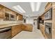Classic kitchen with wooden cabinets, tiled floors, and plenty of counter space at 345 Scrub Oak Way, Monument, CO 80132