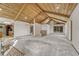 Open-concept living area with a vaulted ceiling, brick fireplace, and staircase at 345 Scrub Oak Way, Monument, CO 80132