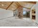 Spacious living room with vaulted wood ceilings, wood-burning stove, and sliding glass doors to balcony at 345 Scrub Oak Way, Monument, CO 80132