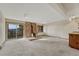 Spacious living room featuring a brick fireplace, sliding glass door with mountain views, and neutral carpeting at 345 Scrub Oak Way, Monument, CO 80132