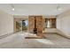 Bright living room with neutral carpet, a brick fireplace, and sliding glass doors showcasing mountain views at 345 Scrub Oak Way, Monument, CO 80132