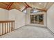 Cozy living space with a vaulted wood ceiling, carpet, and windows for natural light at 345 Scrub Oak Way, Monument, CO 80132