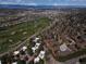 Scenic aerial view of residential area near green golf course and distant mountain views, showcasing prime location at 9400 E Iliff Ave # 411, Denver, CO 80231