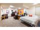 Finished basement features large bed, dresser, sofa, and an entertainment center at 9400 E Iliff Ave # 411, Denver, CO 80231