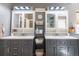 Bathroom features dual sinks, modern lighting and plentiful storage at 9400 E Iliff Ave # 411, Denver, CO 80231