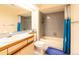 Bathroom with shower, vanity, and toilet, designed with a neutral color palette and good lighting at 9400 E Iliff Ave # 411, Denver, CO 80231