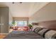 Comfortable bedroom featuring natural light, a large window, and relaxing seating area at 9400 E Iliff Ave # 411, Denver, CO 80231