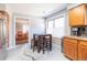 Eat-in kitchen area with stainless steel appliances, wood cabinetry, and unique floor at 9400 E Iliff Ave # 411, Denver, CO 80231