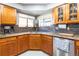 Close-up of kitchen featuring wooden cabinets, stainless steel appliances, and granite countertops at 9400 E Iliff Ave # 411, Denver, CO 80231