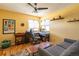 This cozy living room has hardwood floors, a ceiling fan, desk space, and comfortable seating at 9400 E Iliff Ave # 411, Denver, CO 80231