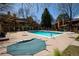 Community pool with lounge chairs and tables surrounded by well-maintained landscaping and townhome buildings at 9400 E Iliff Ave # 411, Denver, CO 80231