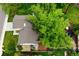 A bird's-eye view of a home featuring a large tree, a play area, and a lush green yard at 9502 W Hialeah Pl, Littleton, CO 80123