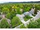 Aerial view of a home nestled among lush green trees in a quiet, residential neighborhood at 9502 W Hialeah Pl, Littleton, CO 80123