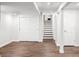 Spacious basement with laminate floors, white walls, storage closets, and stairs leading to the upper levels at 9502 W Hialeah Pl, Littleton, CO 80123