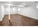 Open basement area with modern laminate flooring and neutral paint, flooded with bright recessed lighting at 9502 W Hialeah Pl, Littleton, CO 80123