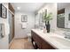 Bathroom featuring double sinks, marble counters, decorative accents, and a glass shower at 9502 W Hialeah Pl, Littleton, CO 80123