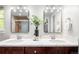 Bathroom with double sinks, marble countertops, modern fixtures, and decorative accents at 9502 W Hialeah Pl, Littleton, CO 80123