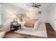 Bedroom features a ceiling fan, stylish decor, and wood floors at 9502 W Hialeah Pl, Littleton, CO 80123