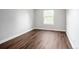 Empty bedroom with wood floors, neutral paint, and natural light from a window at 9502 W Hialeah Pl, Littleton, CO 80123