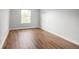 Empty bedroom with wood floors, neutral paint, and natural light from a window at 9502 W Hialeah Pl, Littleton, CO 80123