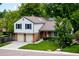 Charming two-story home featuring a brick facade, neutral siding, and a well-manicured lawn at 9502 W Hialeah Pl, Littleton, CO 80123