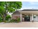 Governor's Hall clubhouse exterior showing entrance with beautiful landscaping and manicured bushes at 9502 W Hialeah Pl, Littleton, CO 80123