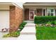Inviting front entrance with a well-maintained lawn, garden bed, and a clear pathway to the front door at 9502 W Hialeah Pl, Littleton, CO 80123