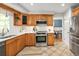 Well-lit kitchen with stainless steel appliances and tile flooring for style and easy cleaning at 9502 W Hialeah Pl, Littleton, CO 80123