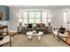 Cozy living room featuring stylish furniture, a bay window with shutters, and warm natural light at 9502 W Hialeah Pl, Littleton, CO 80123