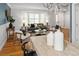 Open-concept living space featuring stylish furniture, hardwood floors, and a modern chandelier at 9502 W Hialeah Pl, Littleton, CO 80123