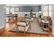 Elegant living and dining area with hardwood floors, sophisticated decor, and ample natural light at 9502 W Hialeah Pl, Littleton, CO 80123