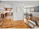 Open-concept living room with hardwood floors seamlessly connects the kitchen and dining area at 9502 W Hialeah Pl, Littleton, CO 80123