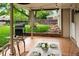 Covered back patio featuring a grill, a playground in the background, and an outdoor dining set for entertaining at 9502 W Hialeah Pl, Littleton, CO 80123