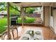 Inviting covered patio with tile flooring, string lights, grill, and outdoor dining area, perfect for entertaining at 9502 W Hialeah Pl, Littleton, CO 80123