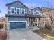 Charming two-story blue home with a two-car garage and well-maintained landscaping at 10294 E Telluride Ct, Commerce City, CO 80022