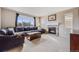 Cozy living room with a stone fireplace, large window, and comfortable seating at 10294 E Telluride Ct, Commerce City, CO 80022