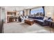 Spacious living room with a large sectional sofa, dining area, and a cozy atmosphere at 10294 E Telluride Ct, Commerce City, CO 80022