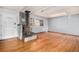 Living room with hardwood floors, wood burning stove and window shutters at 8550 E Davies Pl, Centennial, CO 80112